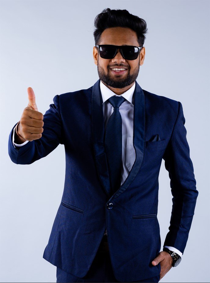Naman Nandurkar, Founder and CEO of Octmi, giving a thumbs-up while wearing a suit