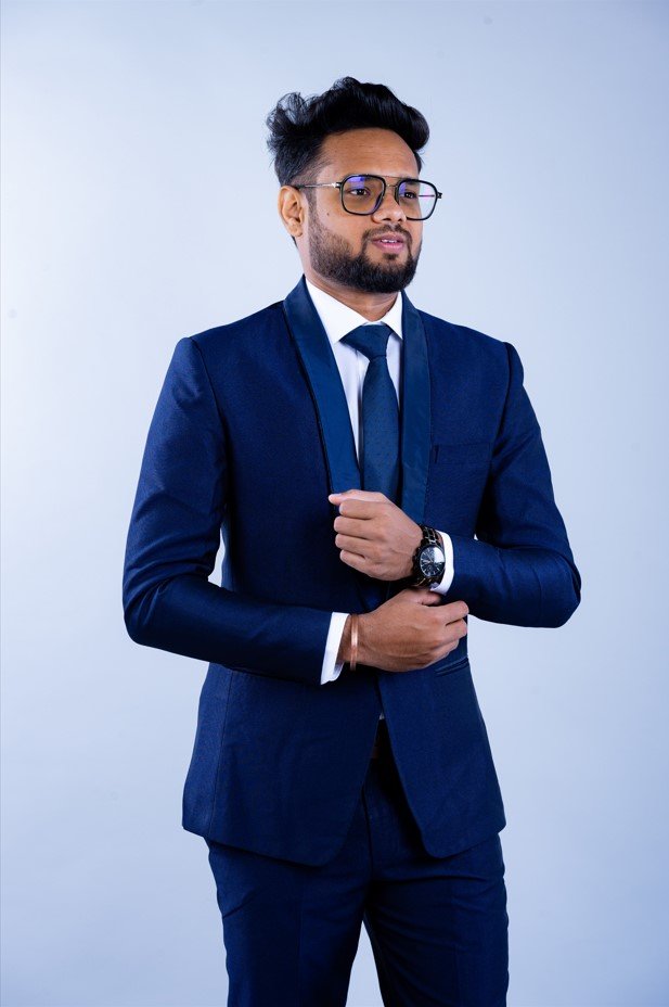 Naman Nandurkar, Founder and CEO of Octmi, posing in a suit with a watch and cufflinks
