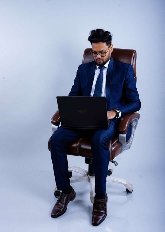 Naman Nandurkar, Founder and CEO of Octmi, working on a laptop in the Octmi office